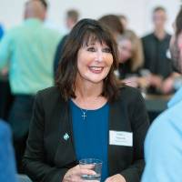 President Philomena Mantella talking with a student